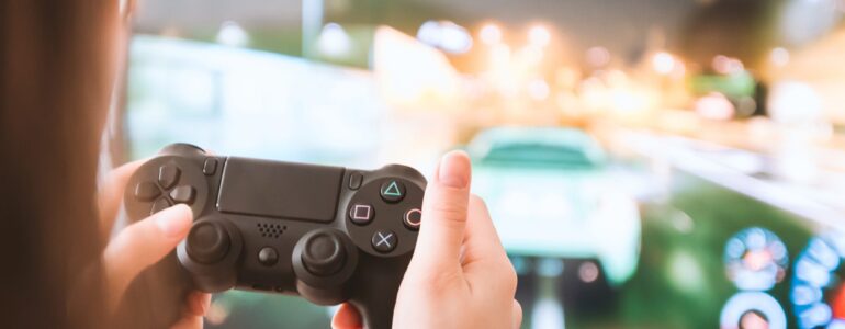 Young girl with gamepad playing games on TV
