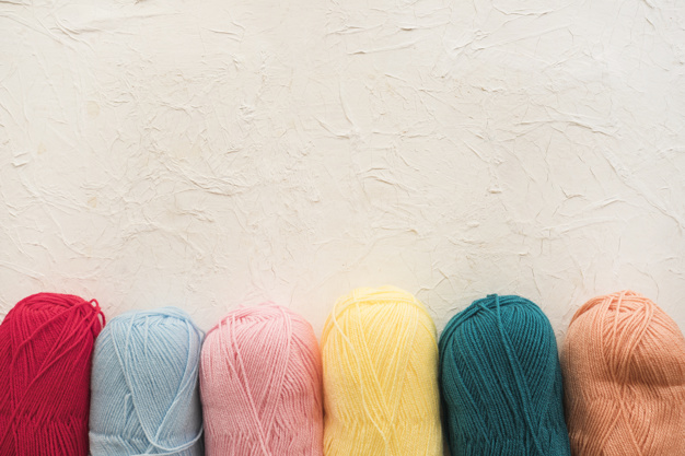 row-of-colorful-skeins-of-yarn_23-2147930364